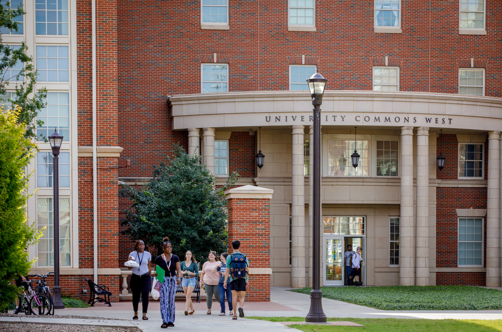 students walking outside university commons west