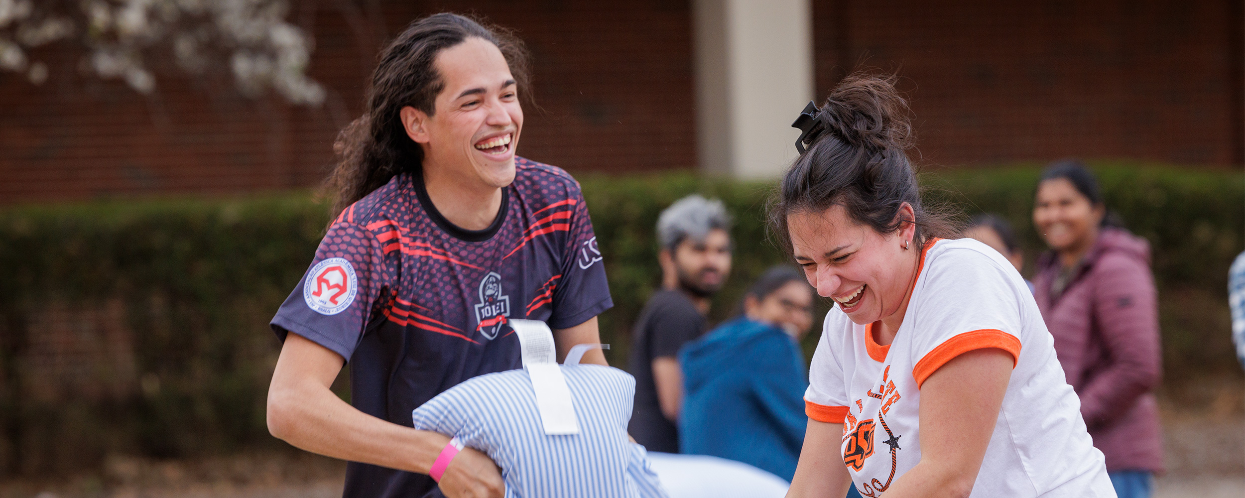 Two students pillow fighting. Two students pillow fighting.